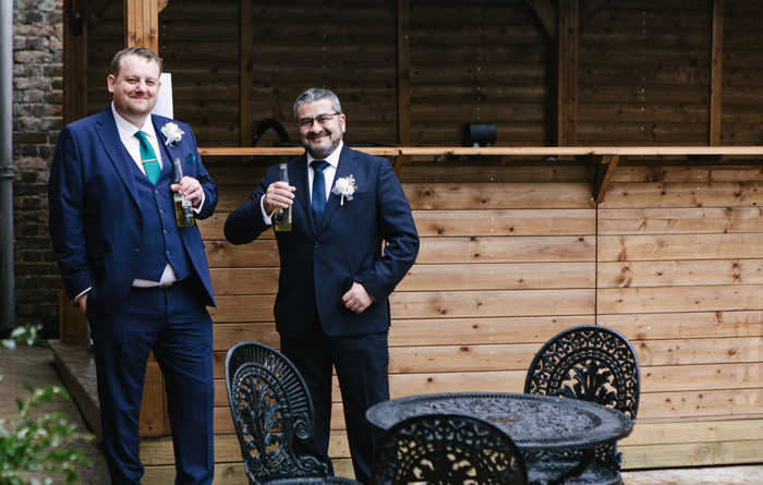 A grrom and groomsmen having a drink at the bar