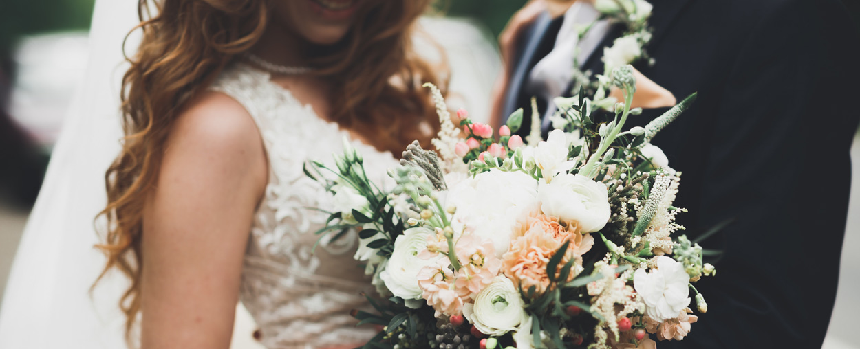 A bride and groom standing outside their wedding
