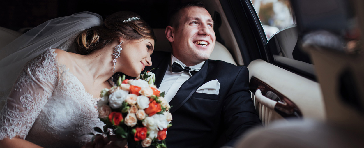 A couple in a wedding car