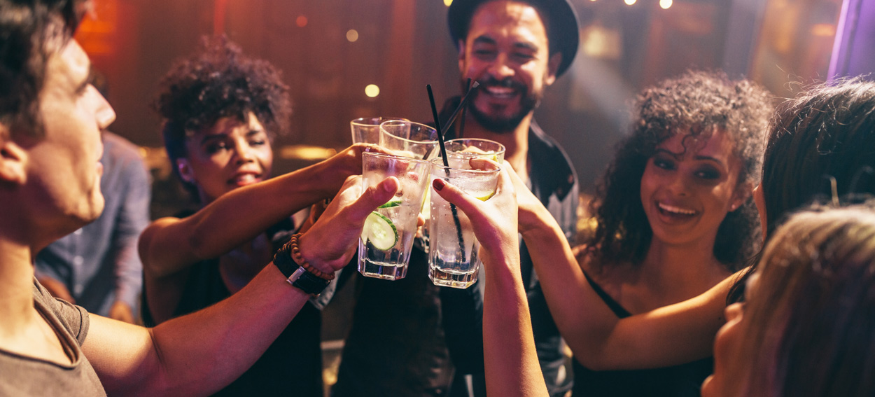 A group of people cheersing at a party