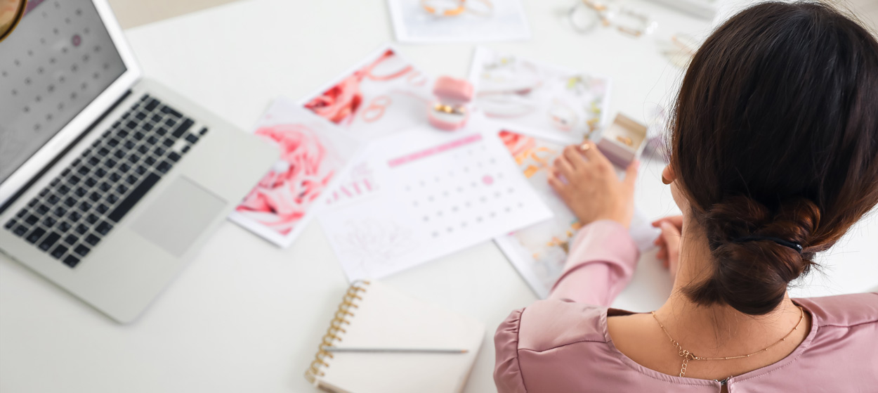 A woman sat at a desk planning her wedding