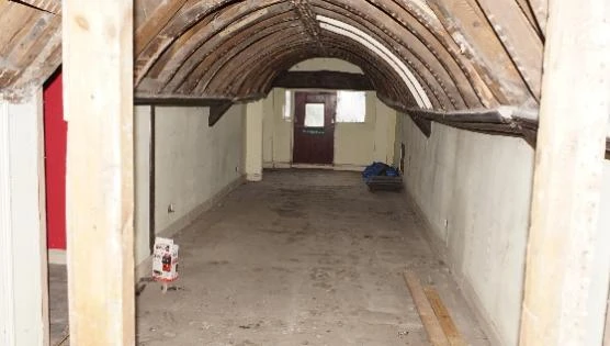 The Medieval Loft at Stone Court House before restoration, with bare vaulted brickwork