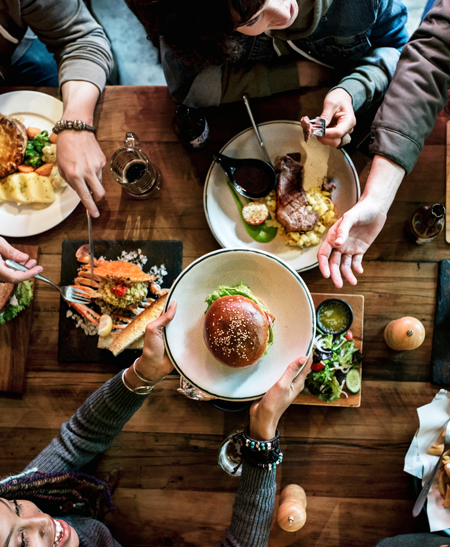 A group of people eating together in a pub