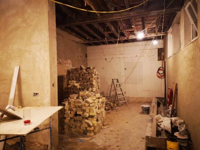 Stone Court House during restoration, with bare walls and building materials