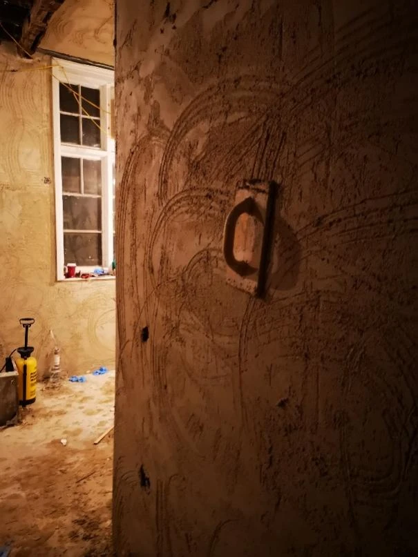 An original door and stripped plaster at Stone Court House during restoration