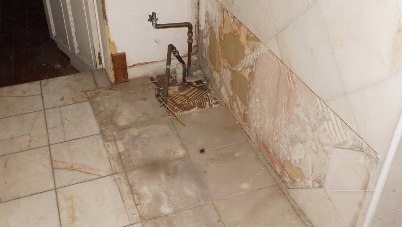 Bathroom area of the Judge Huddlestone room before restoration