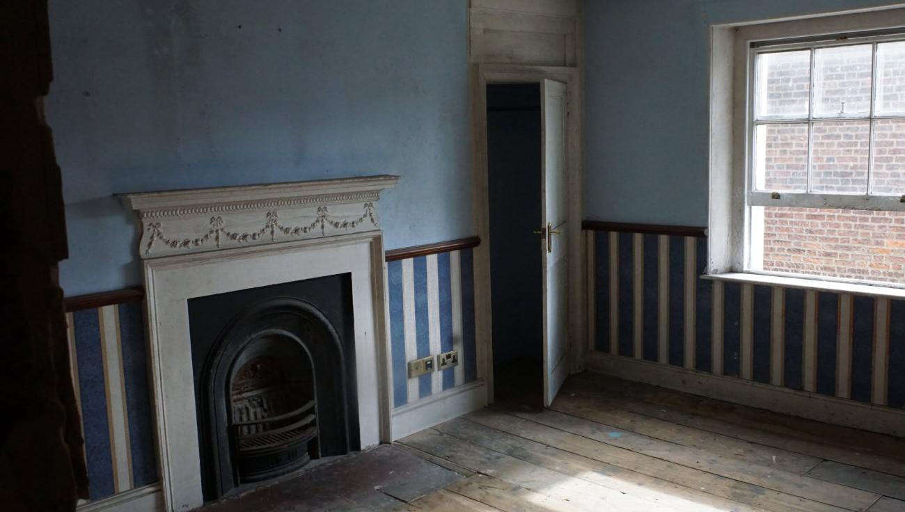 The Judge Kay room at Stone Court House before restoration, showing the fireplace and dado rail