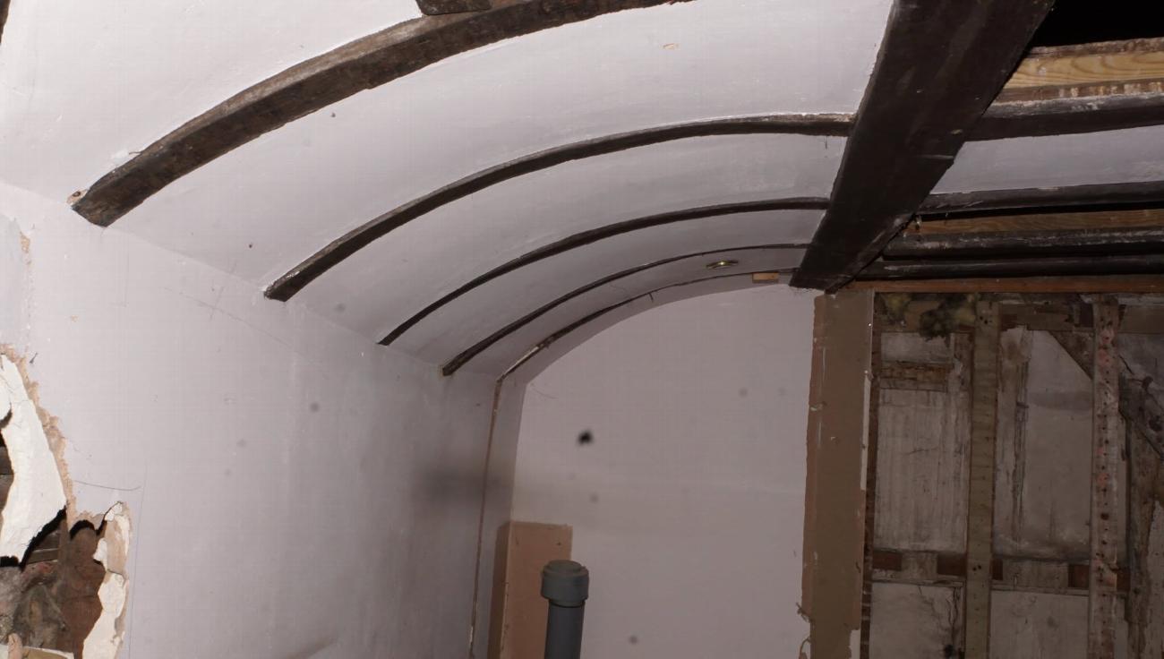 Exposed roof structure in the servants' quarters before restoration