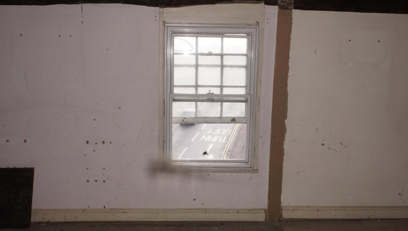 A servants' quarters window before restoration