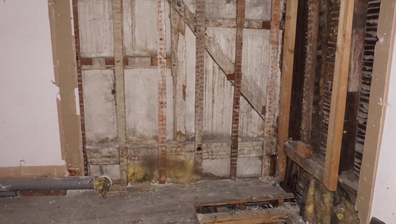 Open timber framing in the servants' quarters before restoration