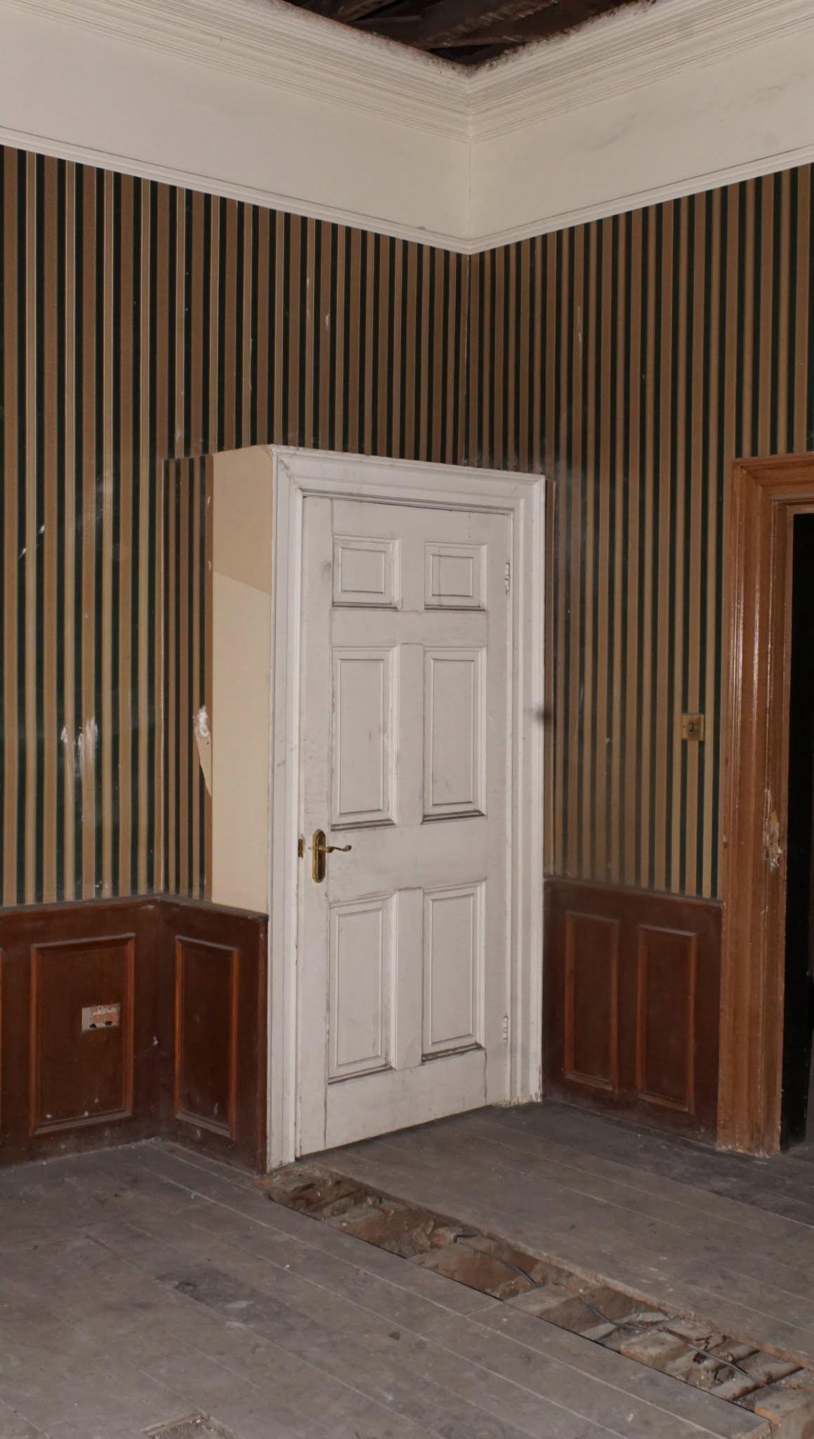 The bridal suite before restoration, showing the doorway and cornice line