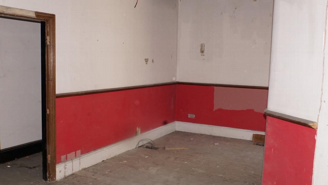 Red-painted walls in the bridal suite before restoration