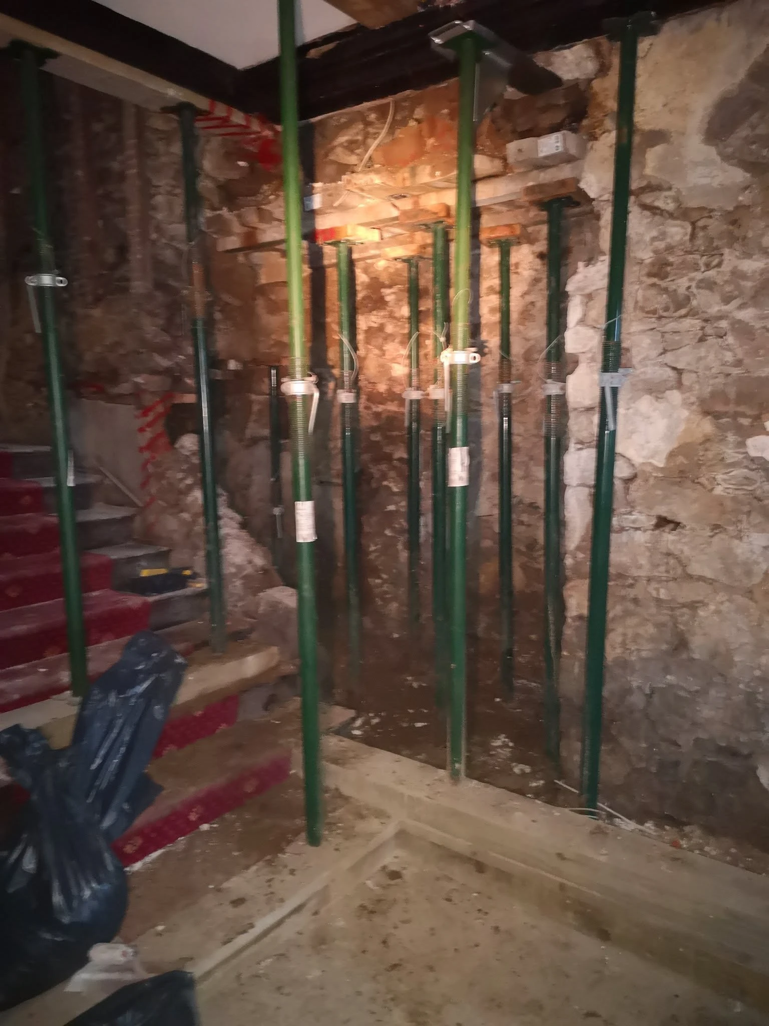 Exposed stonework and props during restoration at Stone Court House