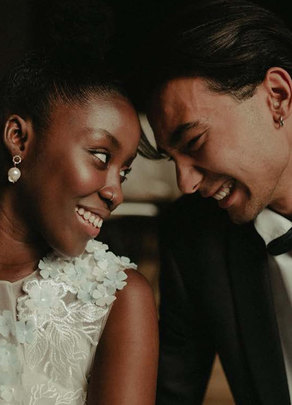 A bride and groom smiling at each other