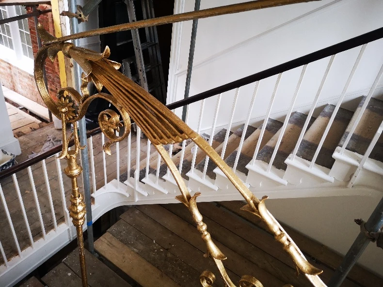 Ironwork detailing on the White Regency Staircase before restoration