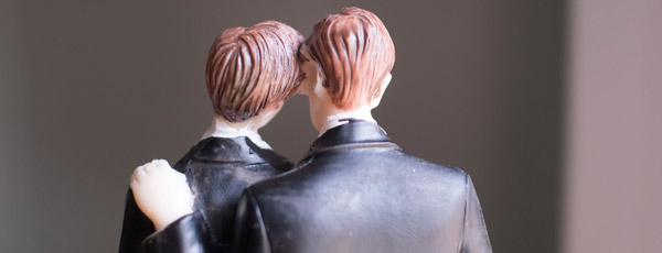 A cake topper with two grooms
